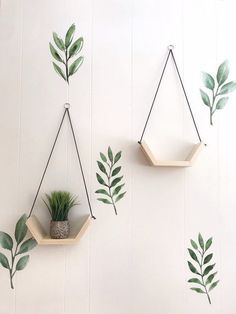 three hanging planters with plants on them, one is made out of wood and the other has green leaves