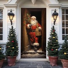 a painting of santa claus on the front door of a house with christmas trees and potted evergreens