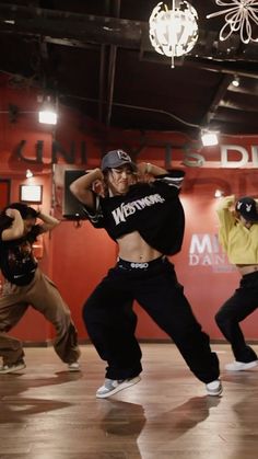 a group of young men and women dancing in a dance studio