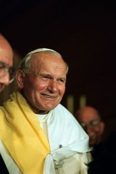 two men standing next to each other smiling