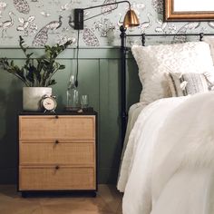 a bedroom with green walls and white bedding