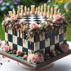 a cake decorated with flowers and chess pieces