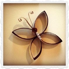 a metal flower is hanging on the wall