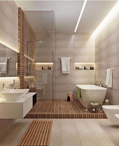 a bathroom with two sinks, a bathtub and a toilet