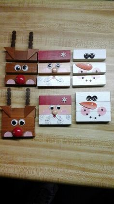 four pieces of paper with eyes and nose on them sitting on a wooden table next to scissors