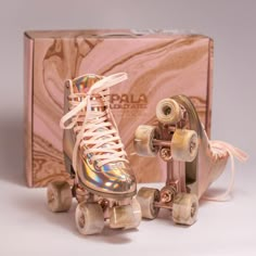 a pair of roller skates sitting in front of a box with the wheels down