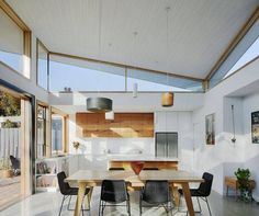 an open kitchen and dining area with white walls