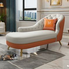 a white and orange chaise lounge chair in a living room with cityscape