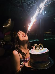 a woman is blowing out the candles on her birthday cake