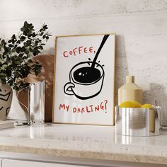 a coffee mug with a spoon in it sitting on top of a counter next to a potted plant