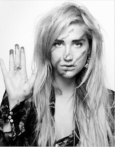 a black and white photo of a woman holding her hand up to the camera while making a peace sign