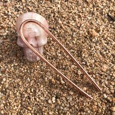 "This minimal sand-textured copper hair pin is formed, hammered, shaped and polished by hand. Used to hold hair buns and instantly dresses up your hair in a subtle but lovely way.  - Made from sturdy 8 gauge solid Copper wire - Textured on one side with hammer - Measures approximately 4.5\" by 1\" or 4\" by 1\" (choose from dropdown menu) Perfect for gifting - Hair pin is packaged in a gift box with twine and a small polishing cloth. Crafted by hand - Each hair pin may not exactly match the one pictured due to its handmade nature, but it makes yours one of a kind! See my other listings for different textured hair forks: Heavy Hammered Texture Hair Fork: https://www.etsy.com/listing/1392312277/hammered-copper-hair-fork-handmade Light Hammered Texture Hair Fork: https://www.etsy.com/listing/ French Hair Pin, Sand Texture, Hair Accessories Bun, Texture Hair, Hair Forks, Cheap Christmas Gifts, Sand Textures, Gifts For Aunt, Hair Buns