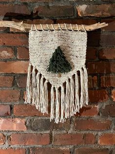 a woven wall hanging with a tree on it