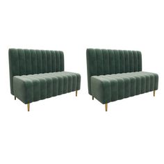 a pair of green velvet sofas with gold legs