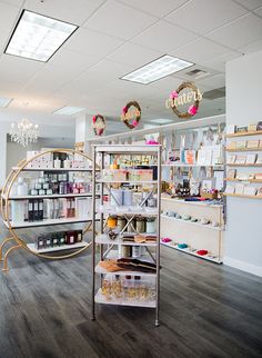 the inside of a store with shelves and chandeliers