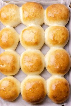 eight rolls in a baking pan on top of parchment paper