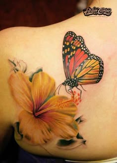 a woman with a butterfly tattoo on her back