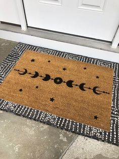 a door mat with the words moon and stars on it in front of a white door