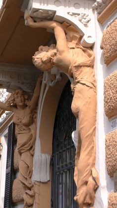 a building with statues on the front and side of it