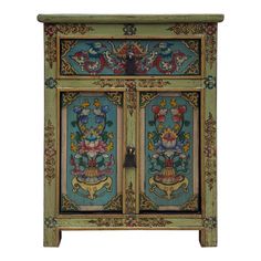 an ornately painted cabinet with flowers and leaves on the doors, is shown against a white background