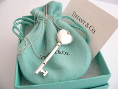 Offered for sale is a gorgeous Tiffany & Co. Sterling Silver Heart Key locket necklace. Hanging from its gorgeous Tiffany silver chain is a very pretty heart locket in the shape of a key - super cool piece! Perfect piece to store one or two pictures or keepsakes, and always keep them close to your heart! The necklace is a wonderful piece that is simple, elegant, and classic all rolled into one. It works perfectly with pretty much any attire your put on, AND adds a nice feminine touch to it. It i Key Locket Necklace, Key Locket, Interlocking Circle Necklace, Silver Link Necklace, Pretty Jewelry Necklaces, Pretty Heart, Tiffany Necklace, Heart Key, Charm Chain