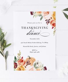 a thanksgiving dinner party with flowers and greenery