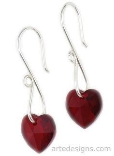 pair of red heart shaped glass earrings with silver earwires, on white background