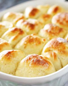 baked bread rolls in a white dish on a table