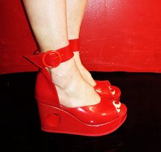 "PEEPHOLE Platform Sandals in Red Patent Handcrafted to order in London Red Sandals with removable wide ankle strap and hole going through Platform at back.  Platform made of wood and covered in red patent leather Genuine leather : upper and platform cover is made of Red patent leather. Wedge height: 1.1\"inches (3cm) at front and 3.1\"inches (8cm) at back Ankle strap is 1.3\"inches (3.3cm) wide and fastens with large red buckle With an arch height of 2\"inches (5cm) these shoes are fitted with Donut Shoes, 1970s Shoes, Pottery Owl, 70s Mode, London Red, Red Sandals, Shoe Company, Shoes Summer, 70s Style