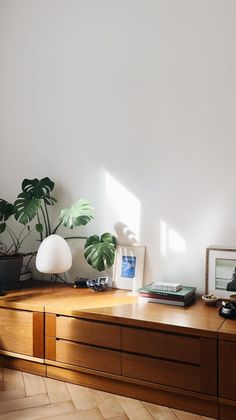 a wooden desk topped with lots of plants