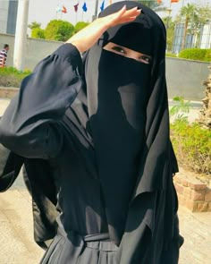 a woman wearing a black hijab covering her face