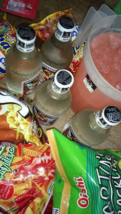 some food and drinks are laying out on the floor next to each other, including soda