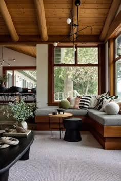 a living room filled with furniture and lots of windows