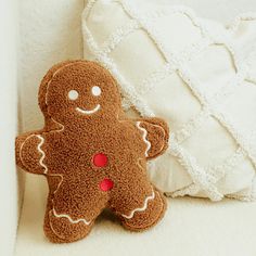 a stuffed ginger sitting next to a pillow