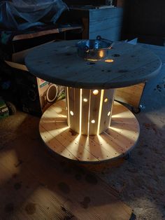 a round table with lights on it in the middle of a room