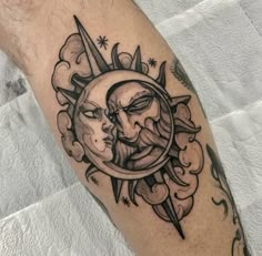 a man with a sun and moon tattoo on his arm