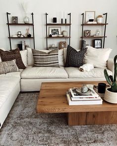 a living room filled with lots of furniture and decor on top of a wooden table