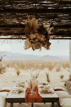 an outdoor dining area with tables and chairs set up for a desert dinner in the middle of nowhere