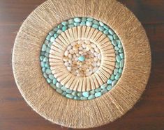 a wooden table topped with a woven basket filled with beads and other things on top of it