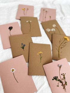 several cards with pressed flowers on them