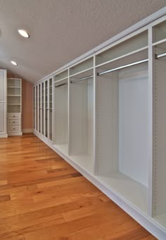 an empty walk in closet with lots of shelves