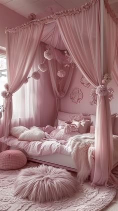 a pink bedroom with lots of pillows on the floor and canopy over the headboard