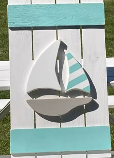 a white and blue chair with a sailboat on it