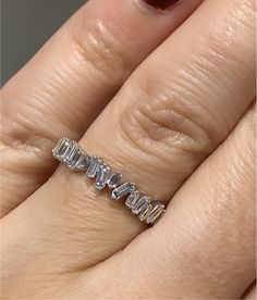 a woman's hand with a diamond ring on her left hand and the word love spelled