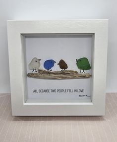 three little birds sitting on a branch in a white frame with the words, all because two people fell in love