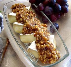 grapes and crackers are on a plate next to other food items such as fruit