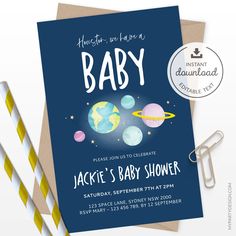 a baby shower card with space and planets on it, next to two straws