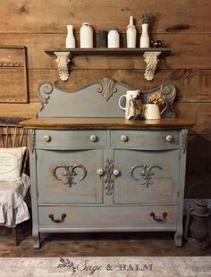 an old dresser is painted blue and has ornate carvings on it