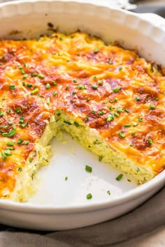 a cheesy quiche in a white casserole dish