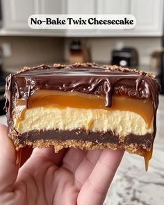 someone holding up a piece of no - bake twix cheesecake